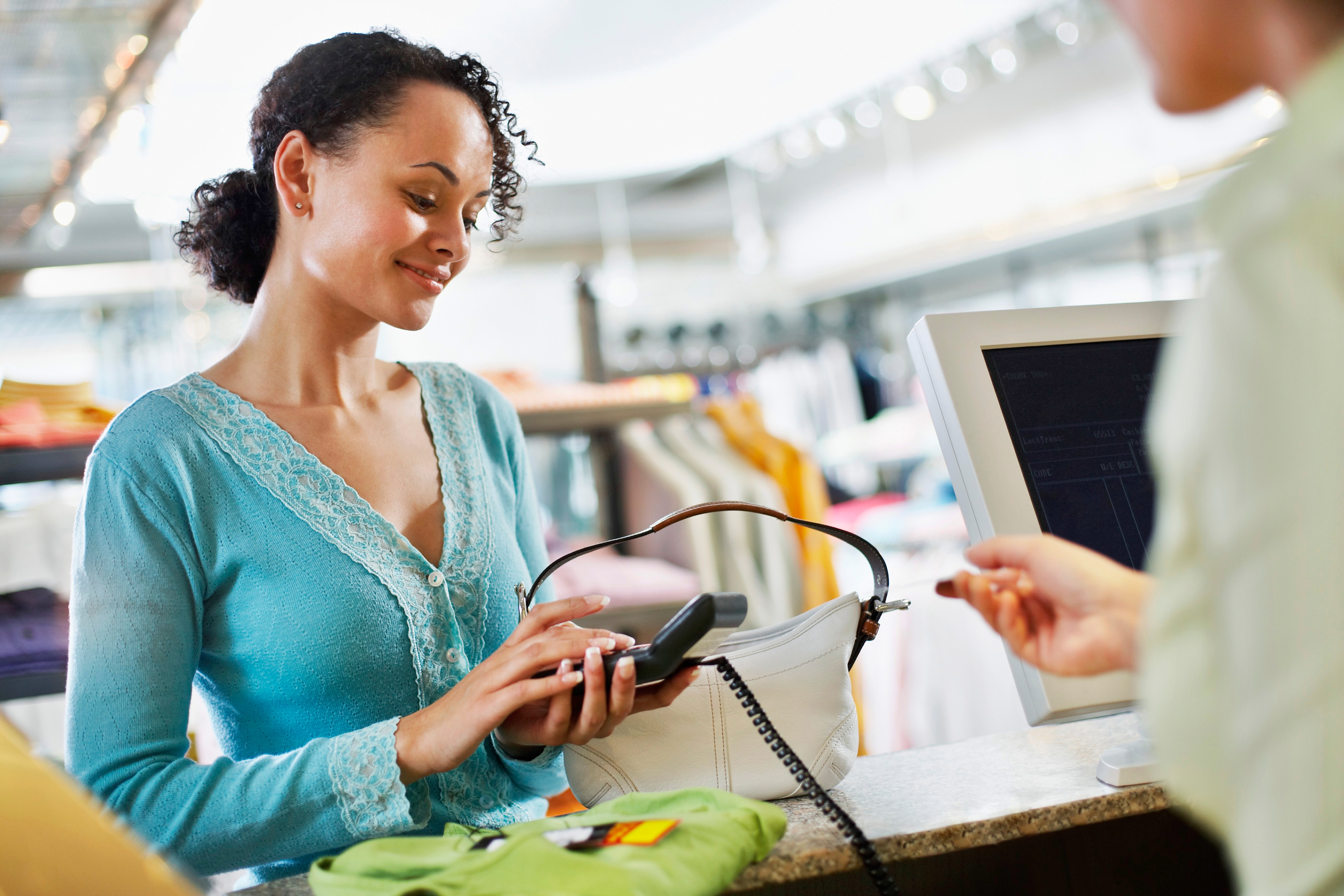 a woman is making the payment