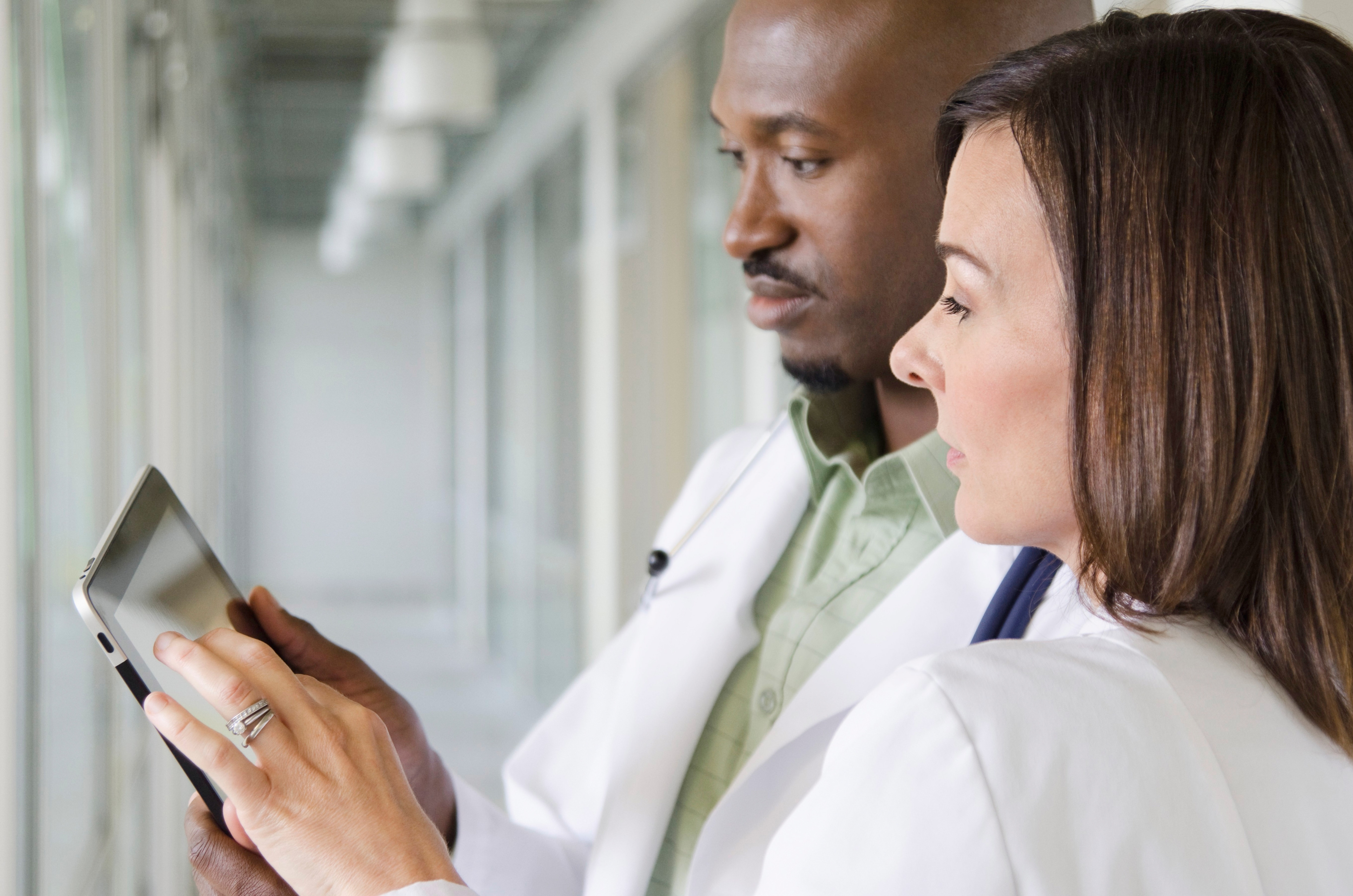Two healthcare professionals looking at a tablet