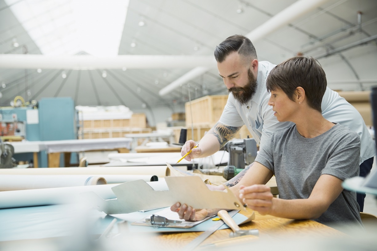 Two office workers looking over a work materials together