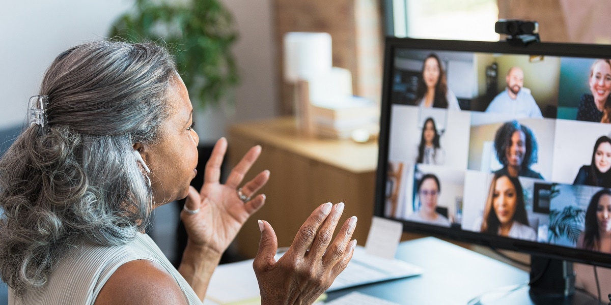 Woman on a Zoom type call with co-workers