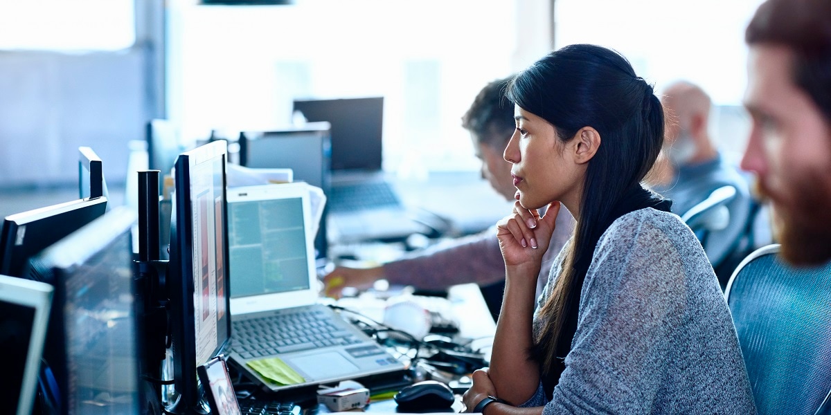 Woman in an office looking at a computer screen
