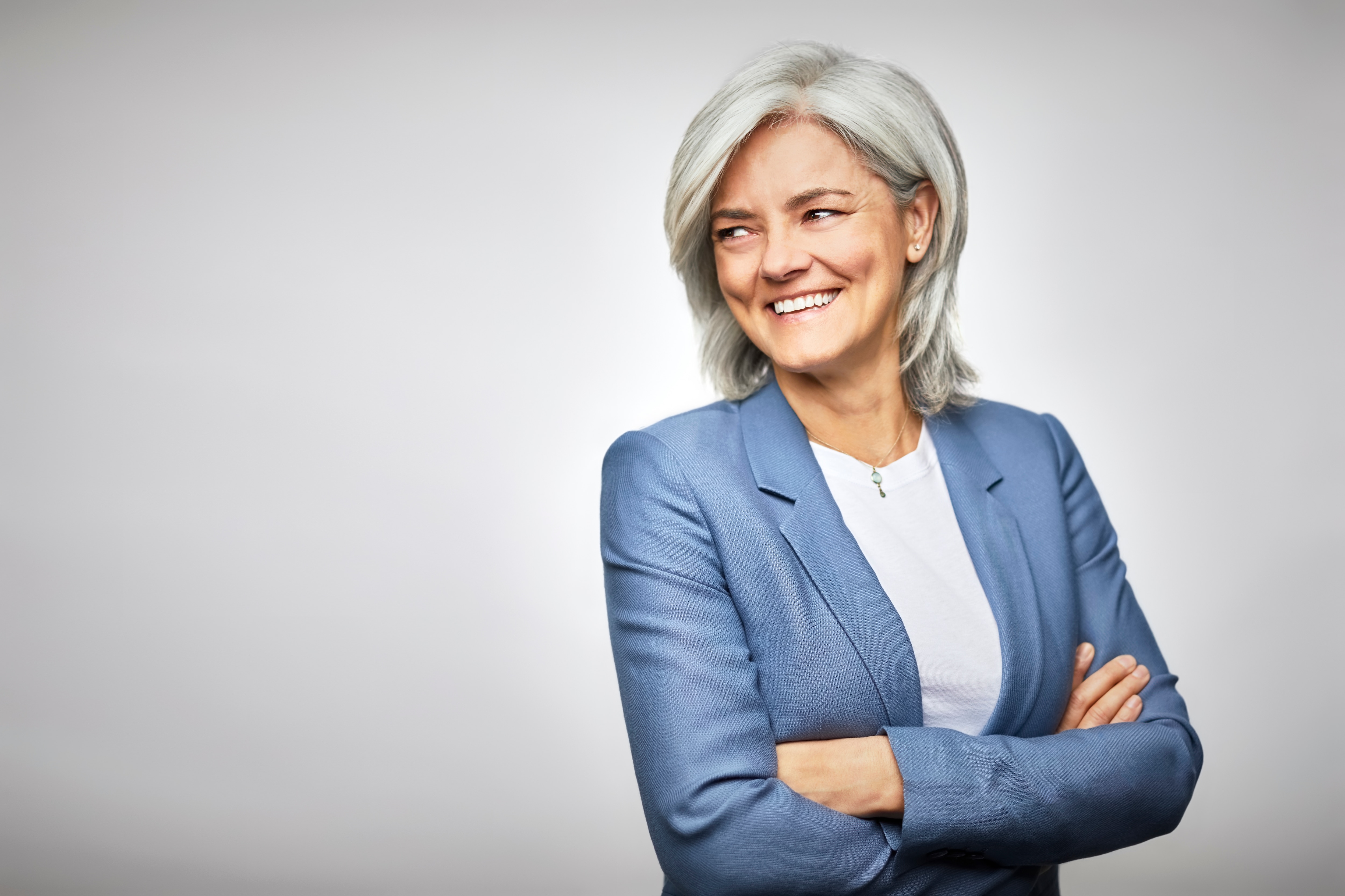 Woman in a gray suit smiling