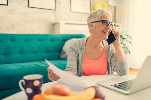 Woman working at computer and talking on phone