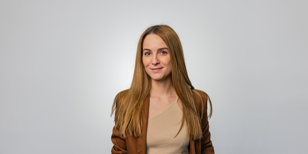 woman in brown blazer 