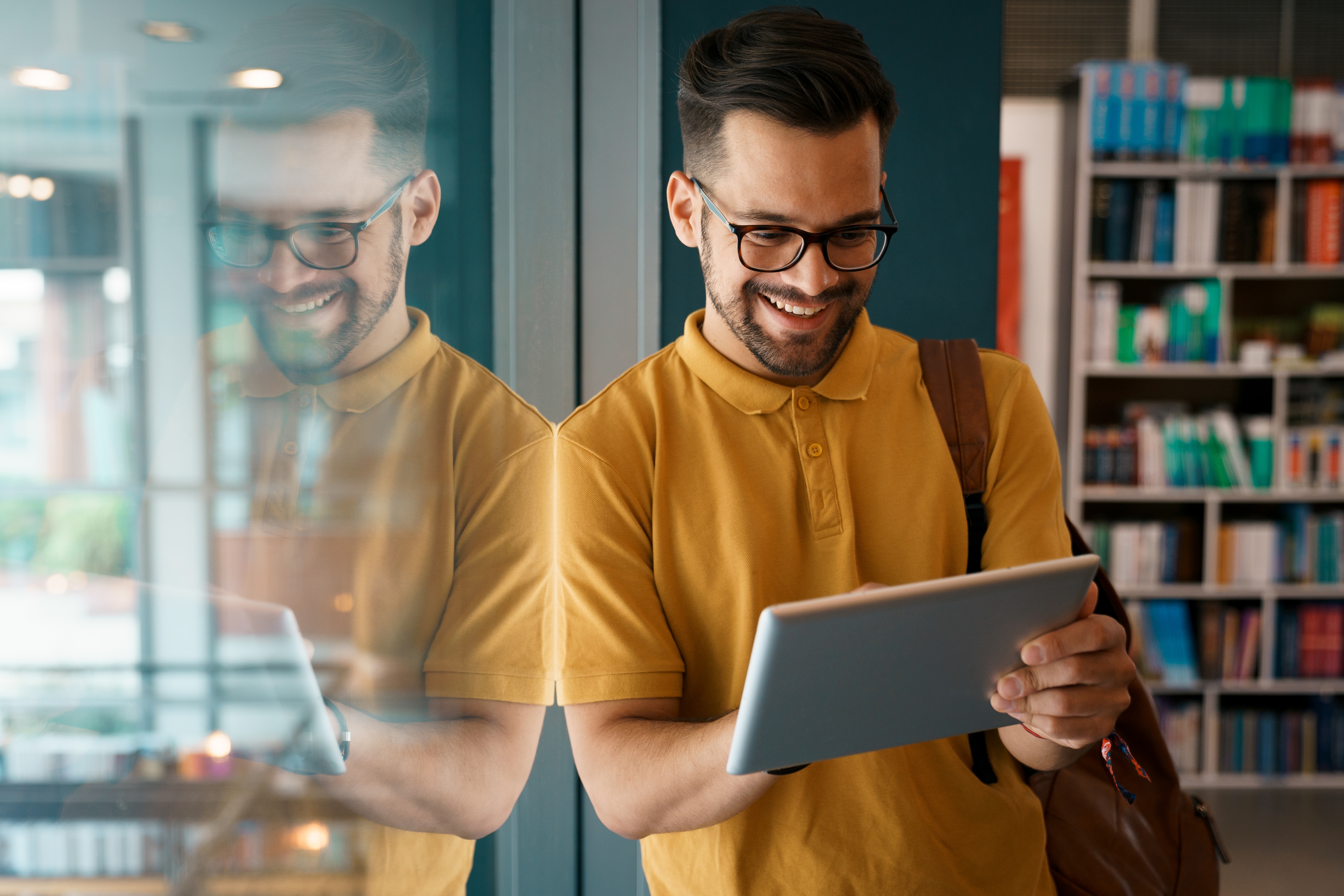 Man looking at iPad in library