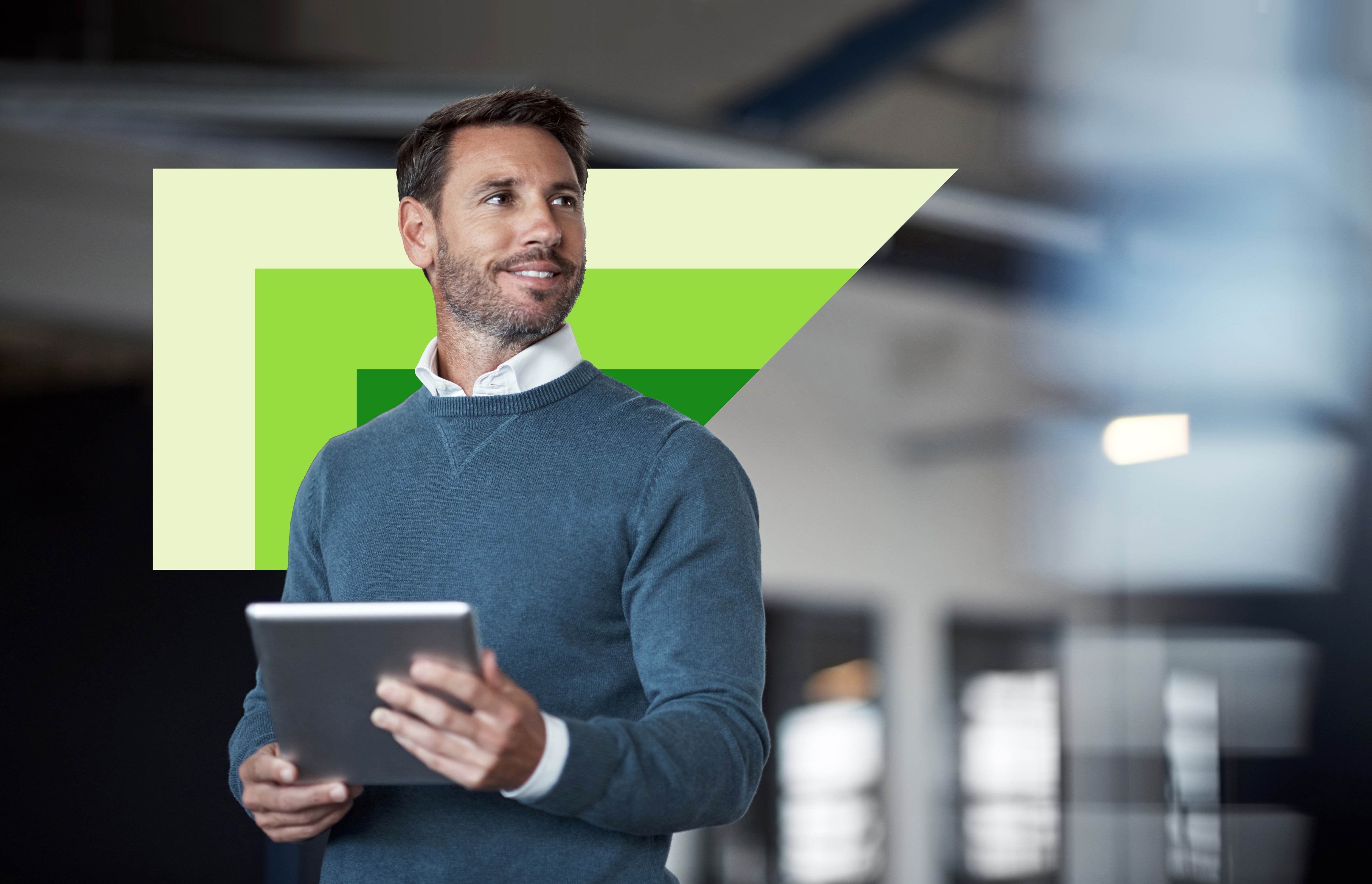 man standing with an ipad in office