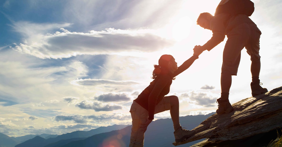 two-people-climbing-mountain