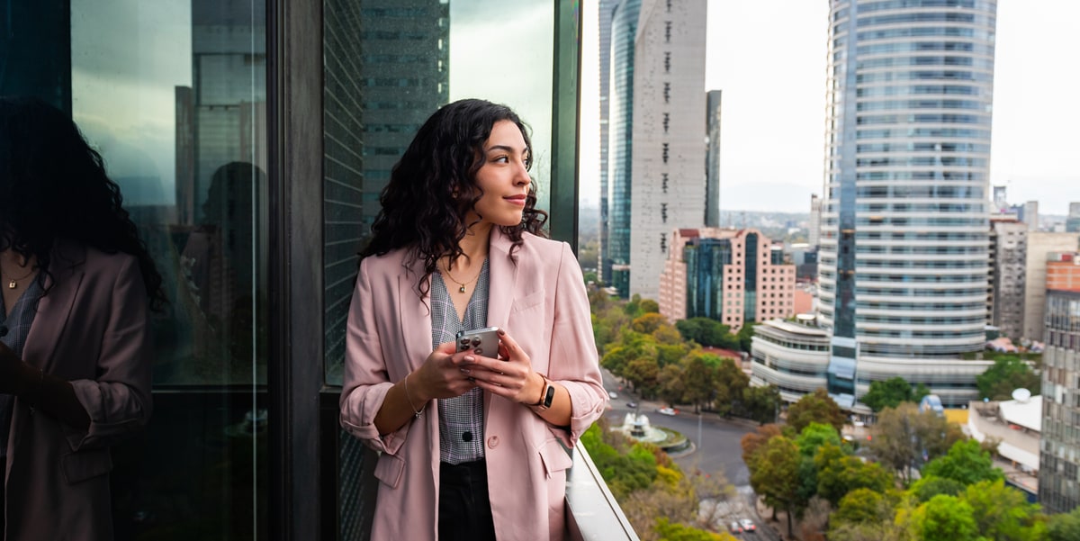 woman looking out from balcony