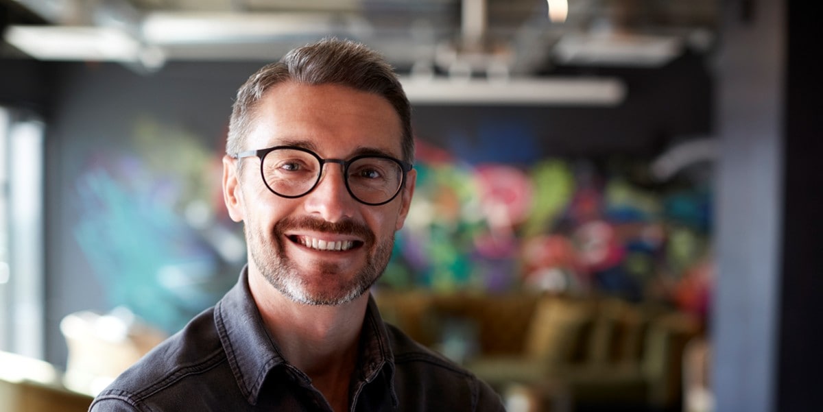 man with glasses smiling