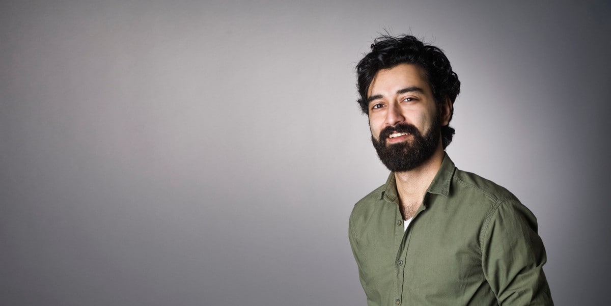 man in green shirt looking at camera