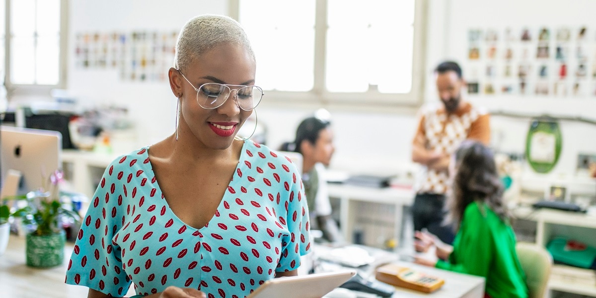 Woman in an office looking at a tablet computer